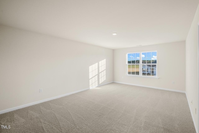 spare room with light colored carpet