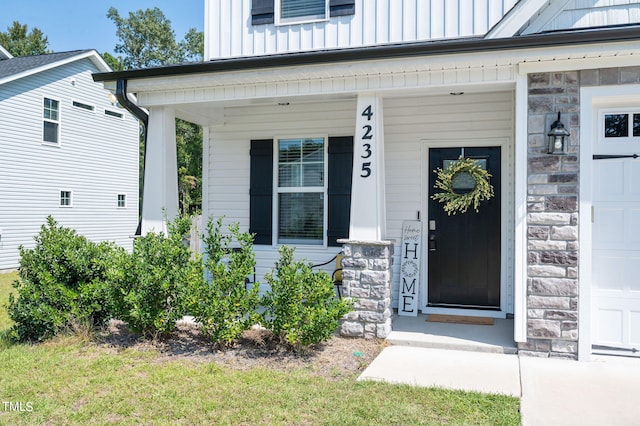 doorway to property featuring covered porch