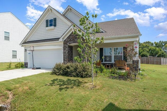 craftsman house featuring a porch, an attached garage, fence, concrete driveway, and a front lawn