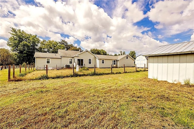 view of yard featuring an outbuilding and fence