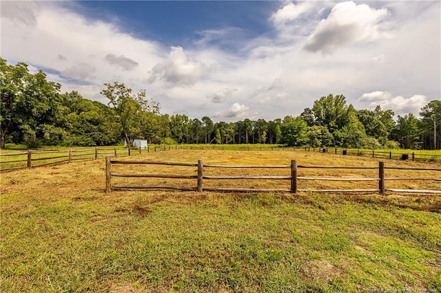 view of yard with a rural view and fence