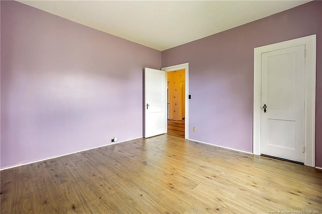 unfurnished room with wood finished floors