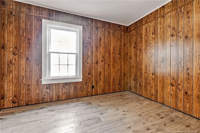 empty room with wood walls and wood finished floors