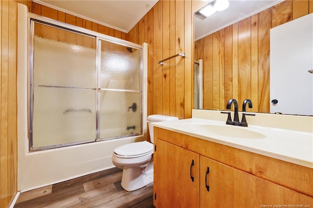 full bathroom featuring wood walls, vanity, and toilet