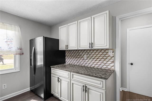 kitchen with dark wood-type flooring, white cabinetry, and stainless steel refrigerator with ice dispenser