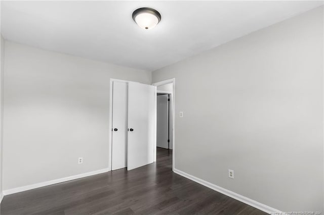 empty room with dark hardwood / wood-style floors