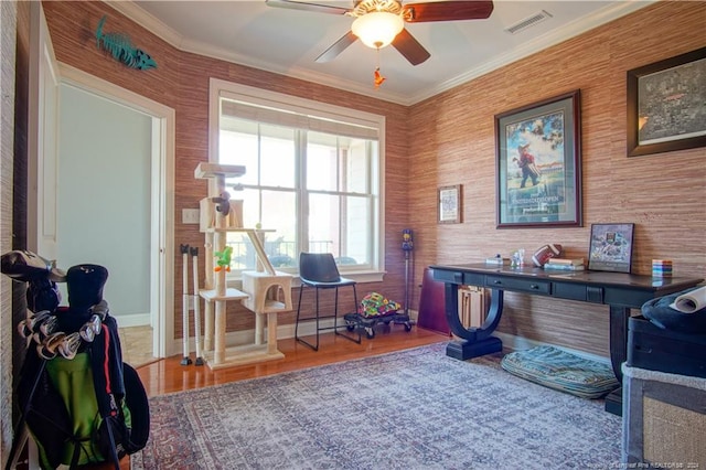 office area featuring ceiling fan, ornamental molding, and wood-type flooring