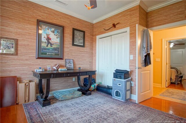 home office with crown molding, hardwood / wood-style flooring, and ceiling fan