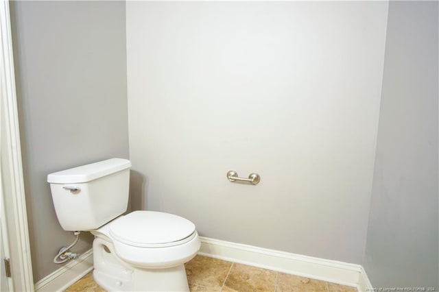 bathroom with toilet and tile patterned floors