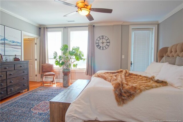 bedroom featuring ceiling fan, hardwood / wood-style flooring, and ornamental molding