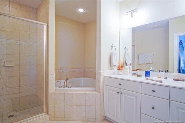 bathroom featuring shower with separate bathtub and vanity