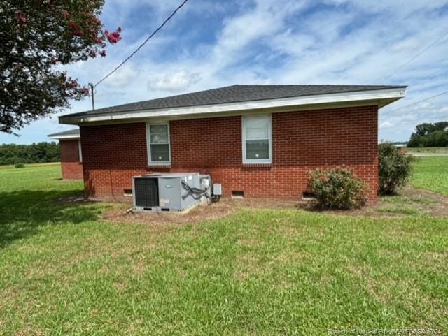 view of property exterior with a yard and central AC