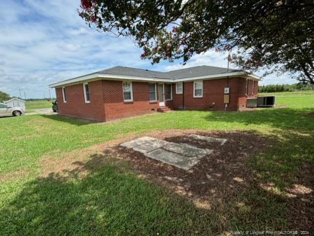 rear view of house with a yard