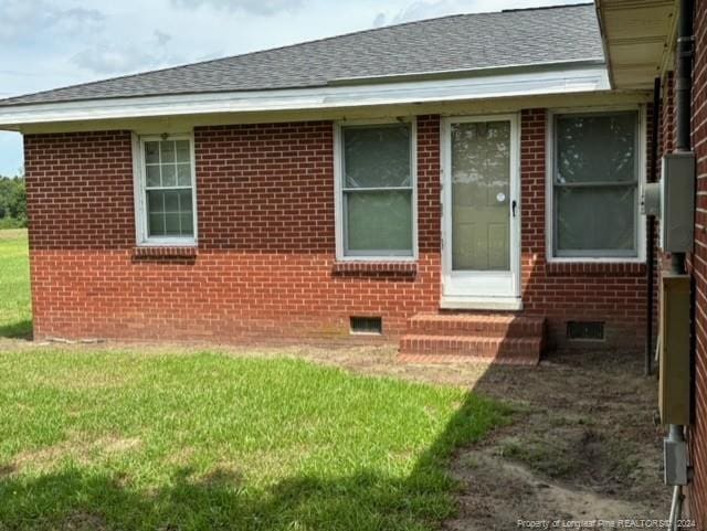 view of side of home with a lawn