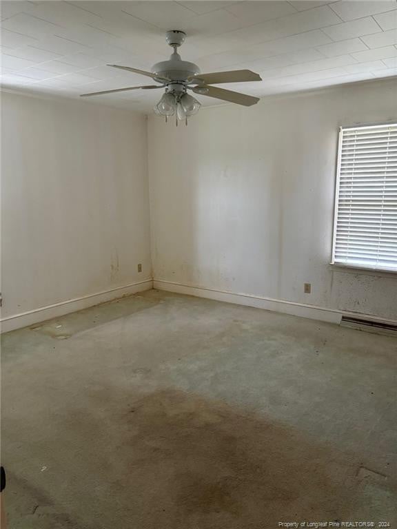 unfurnished room featuring ceiling fan and a baseboard radiator