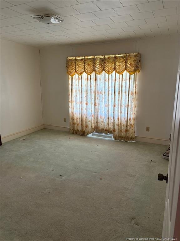 empty room with plenty of natural light and carpet