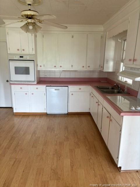 kitchen featuring white appliances, ceiling fan, and light hardwood / wood-style floors