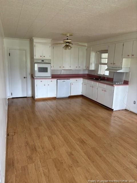 kitchen with white cabinets, white appliances, hardwood / wood-style floors, and ceiling fan