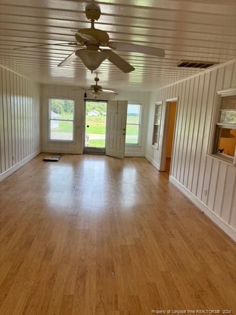 interior space with wood-type flooring and ceiling fan