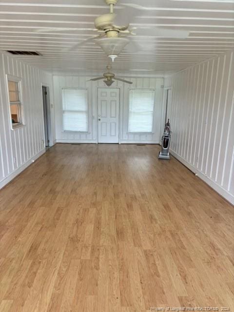 unfurnished living room featuring light wood-type flooring and ceiling fan