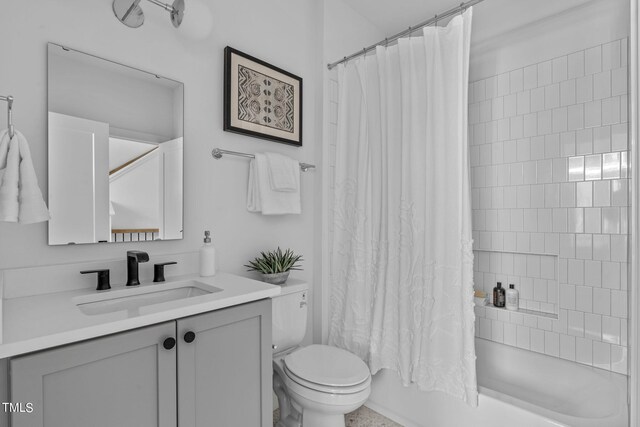 full bathroom featuring vanity, shower / bath combination with curtain, and toilet