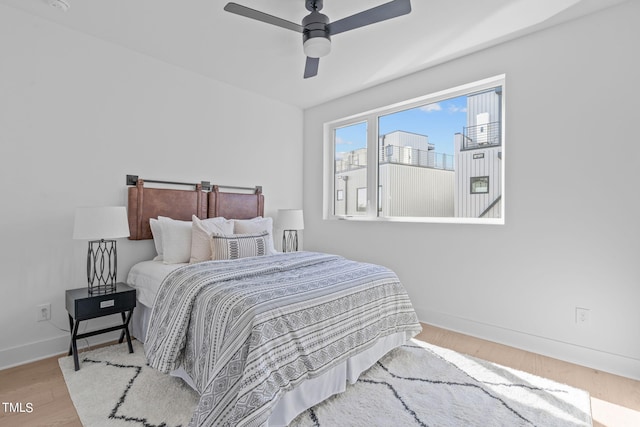 bedroom with light wood-type flooring and ceiling fan