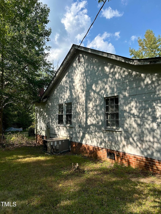 view of side of home with a lawn