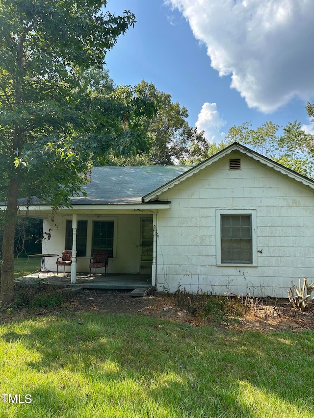 rear view of house with a yard