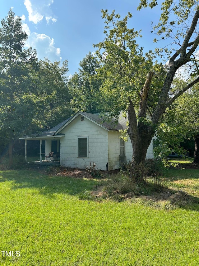 view of side of property with a yard