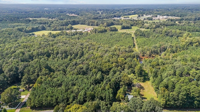 drone / aerial view featuring a forest view