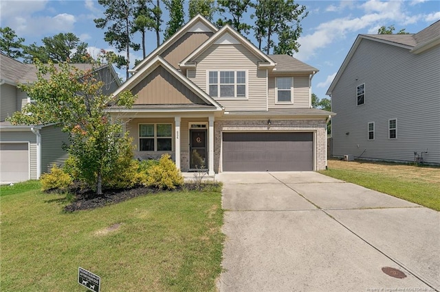 craftsman house with a garage and a front lawn