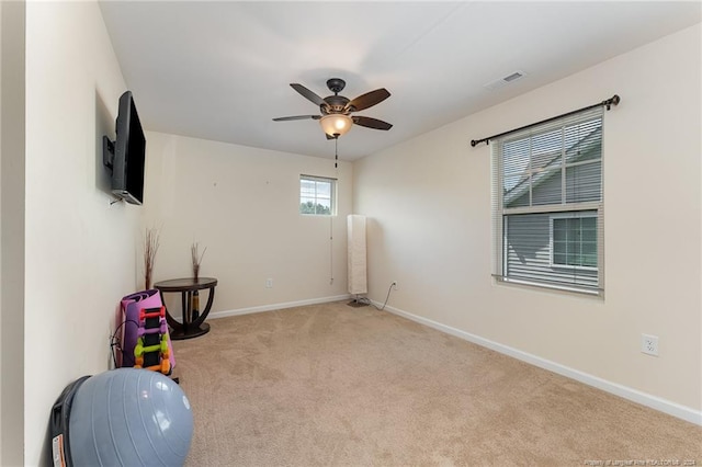 workout room with a ceiling fan, carpet, visible vents, and baseboards