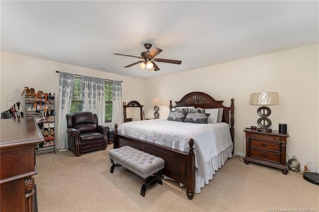 bedroom with ceiling fan and light carpet