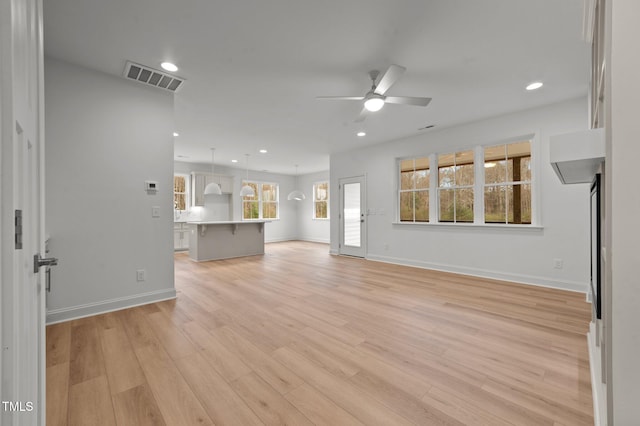 unfurnished living room with ceiling fan and light hardwood / wood-style floors