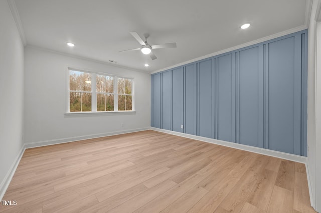 spare room with ceiling fan, ornamental molding, and light hardwood / wood-style flooring