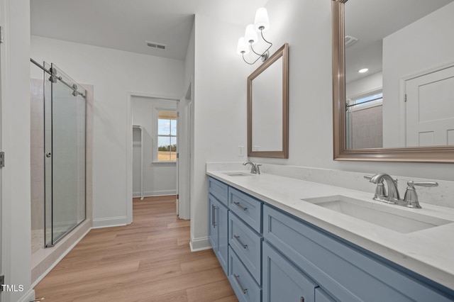 bathroom featuring vanity, hardwood / wood-style floors, and an enclosed shower