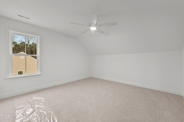 additional living space featuring vaulted ceiling, ceiling fan, and carpet