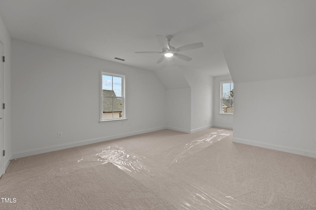 bonus room featuring plenty of natural light, ceiling fan, and vaulted ceiling