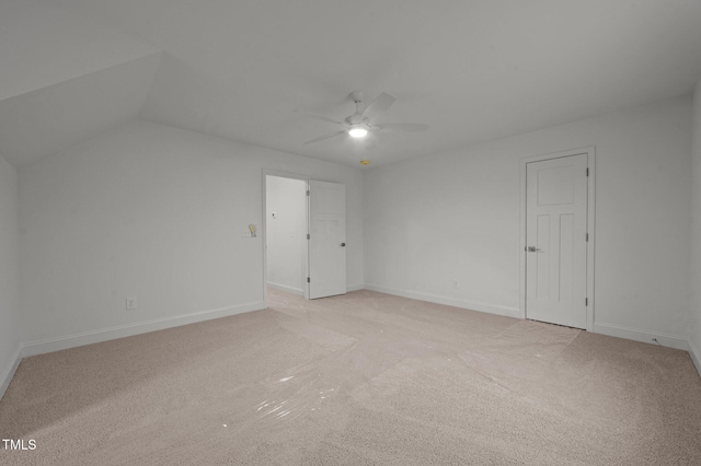 additional living space with lofted ceiling, light colored carpet, and ceiling fan