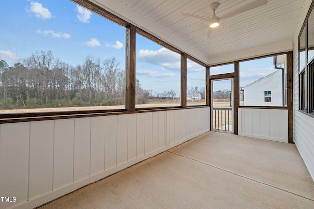 unfurnished sunroom featuring ceiling fan