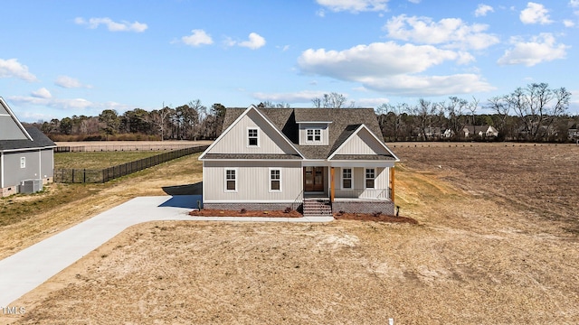 view of front of home featuring a porch, roof with shingles, and fence