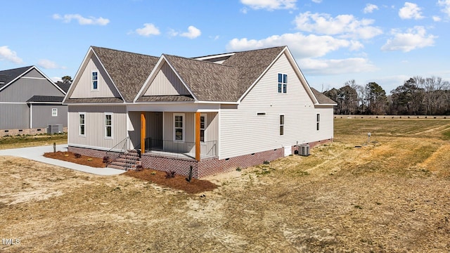 view of front of house featuring crawl space, covered porch, central AC unit, and roof with shingles