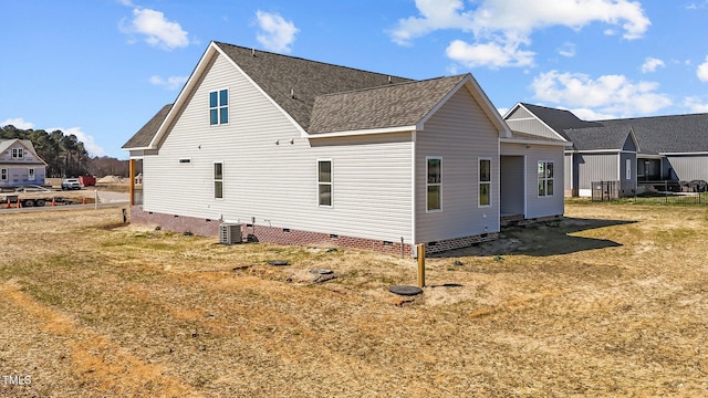 view of property exterior featuring roof with shingles, central AC unit, and crawl space