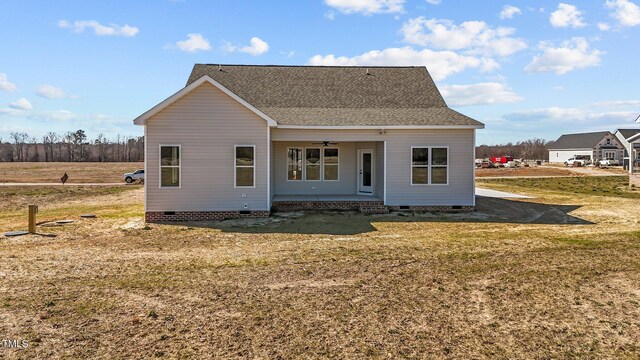 rear view of house featuring roof with shingles, a yard, covered porch, crawl space, and ceiling fan