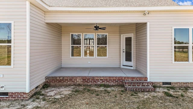 entrance to property with a shingled roof, crawl space, and a ceiling fan