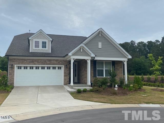 view of front of home featuring covered porch and a garage