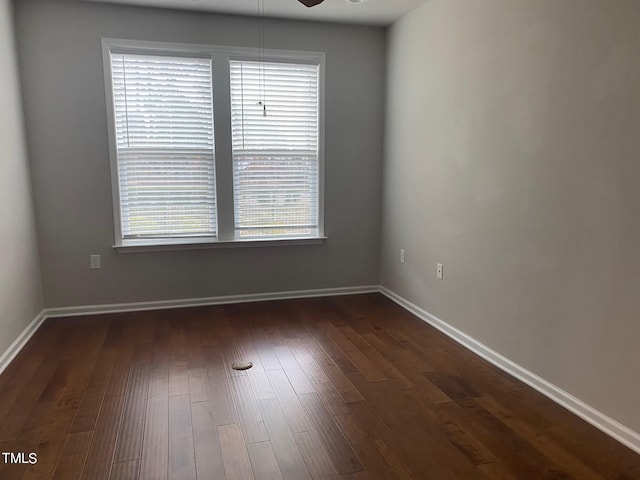 empty room featuring ceiling fan and dark hardwood / wood-style floors