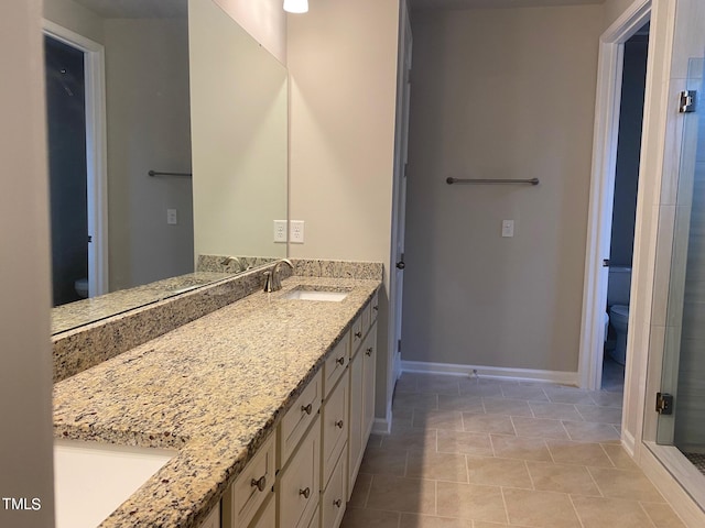 bathroom with an enclosed shower, tile patterned flooring, toilet, and vanity