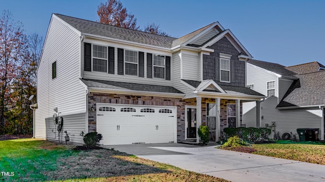 view of front of house with a front yard and a garage