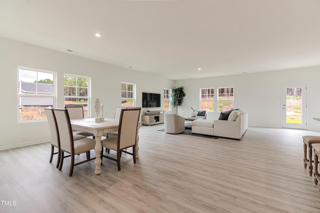 dining room with recessed lighting, light wood-style flooring, and baseboards